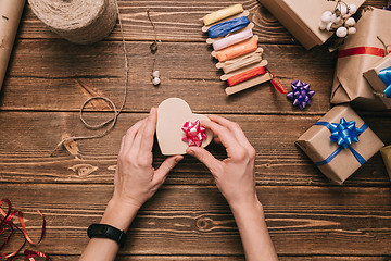 Image showing Crop hands decorating present