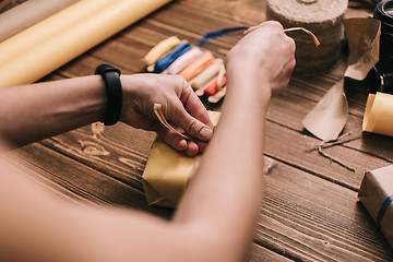 Image showing Crop hands decorating present