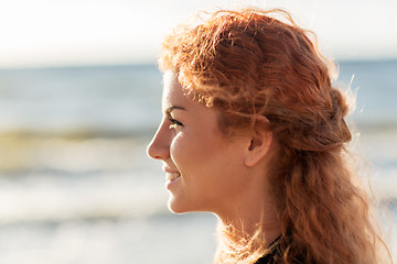 Image showing happy young redhead woman face on beach