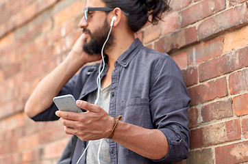 Image showing man with earphones and smartphone on street