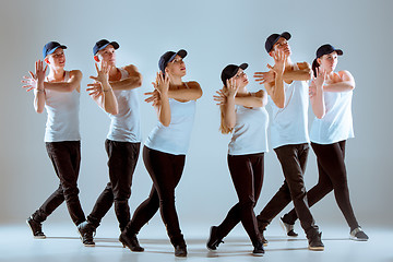 Image showing Group of men and women dancing hip hop choreography