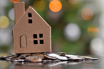 Image showing Model of house with coins on wooden table