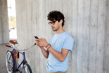 Image showing man with smartphone and fixed gear bike on street