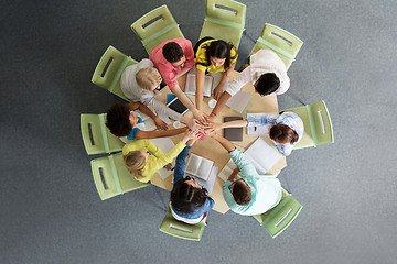 Image showing group of international students with hands on top