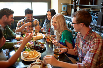 Image showing friends dining and drinking beer at restaurant