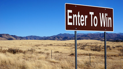 Image showing Enter To Win brown road sign