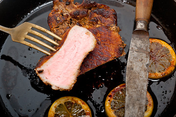 Image showing pork chop seared on iron skillet