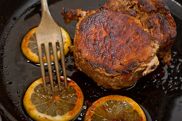 Image showing pork chop seared on iron skillet