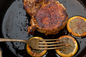 Image showing pork chop seared on iron skillet