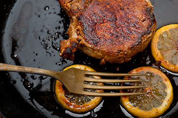 Image showing pork chop seared on iron skillet