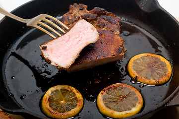 Image showing pork chop seared on iron skillet