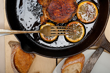 Image showing pork chop seared on iron skillet