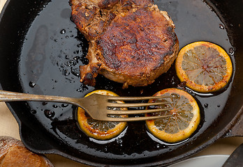 Image showing pork chop seared on iron skillet