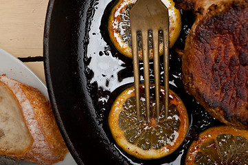 Image showing pork chop seared on iron skillet