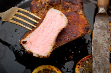 Image showing pork chop seared on iron skillet