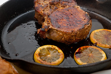 Image showing pork chop seared on iron skillet