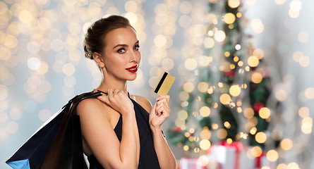 Image showing woman with bank card and shopping bags