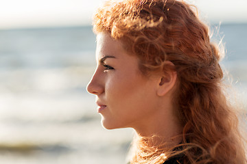 Image showing happy young redhead woman face on beach