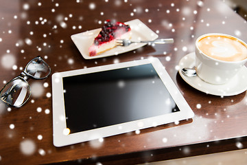 Image showing close up of tablet pc, coffee cup and cake