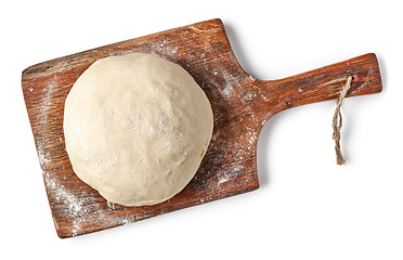 Image showing fresh raw dough on wooden board