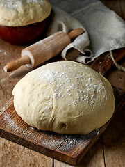 Image showing fresh raw dough on wooden table