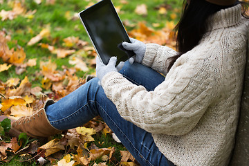 Image showing close up of woman with tablet pc in autumn park