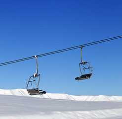 Image showing Chair-lift and blue clear sky at sun day