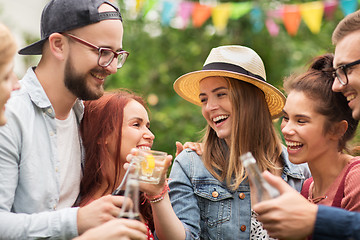 Image showing happy friends clinking glasses at summer garden