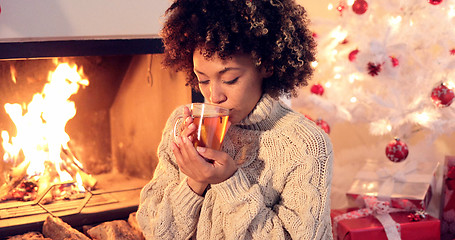 Image showing Young woman drinking spicy lemon tea