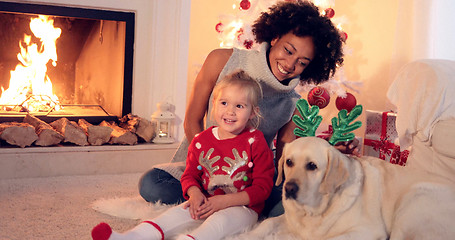 Image showing Family Christmas celebration next to fireplace