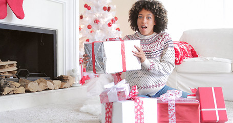 Image showing Surprised woman holding a large Christmas gift