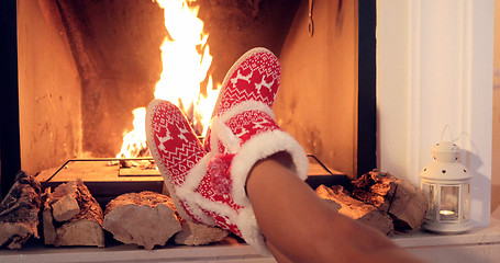 Image showing Young woman relaxing in Christmas booties