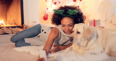 Image showing Cute young woman taking a selfie with her dog