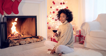 Image showing Woman in leggings and sweater sits by white tree