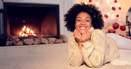 Image showing Woman by fireplace and wearing warm sweater