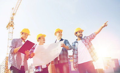 Image showing group of builders with tablet pc and blueprint