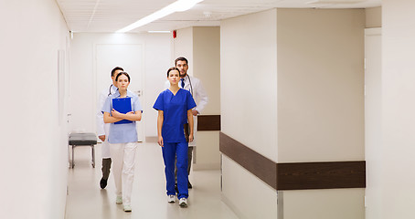 Image showing group of medics or doctors walking along hospital