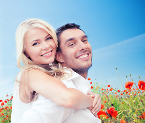 Image showing happy couple having fun over poppy flowers field