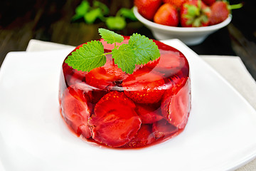 Image showing Jelly strawberry with mint and berries on board