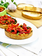Image showing Bruschetta with tomatoes and peppers in plate on napkin