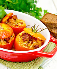 Image showing Tomatoes stuffed with bulgur in pan on napkin