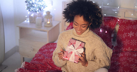 Image showing Smiling African woman holding Christmas gift