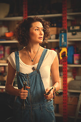 Image showing car mechanic woman in blue overalls with a wrench in her hand