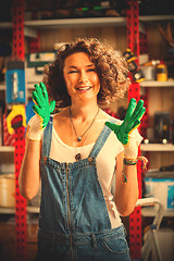 Image showing Car painter beautiful smiling woman in a blue denim overalls