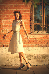 Image showing georgeous woman in white dress dancing in the street