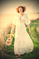 Image showing Pretty smiling Woman Outdoors with wicker bag with natural meal 