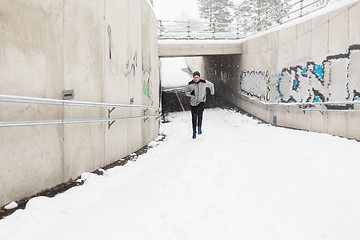 Image showing man running out of subway tunnel in winter