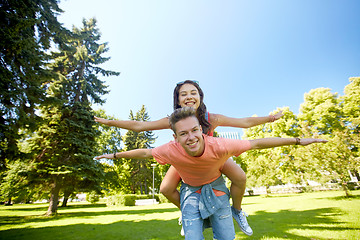 Image showing happy teenage couple having fun at summer park