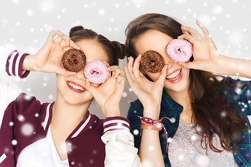 Image showing happy pretty teenage girls with donuts having fun