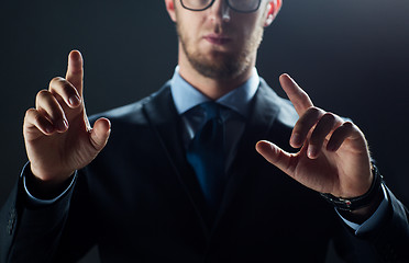 Image showing close up of businessman touching virtual screen